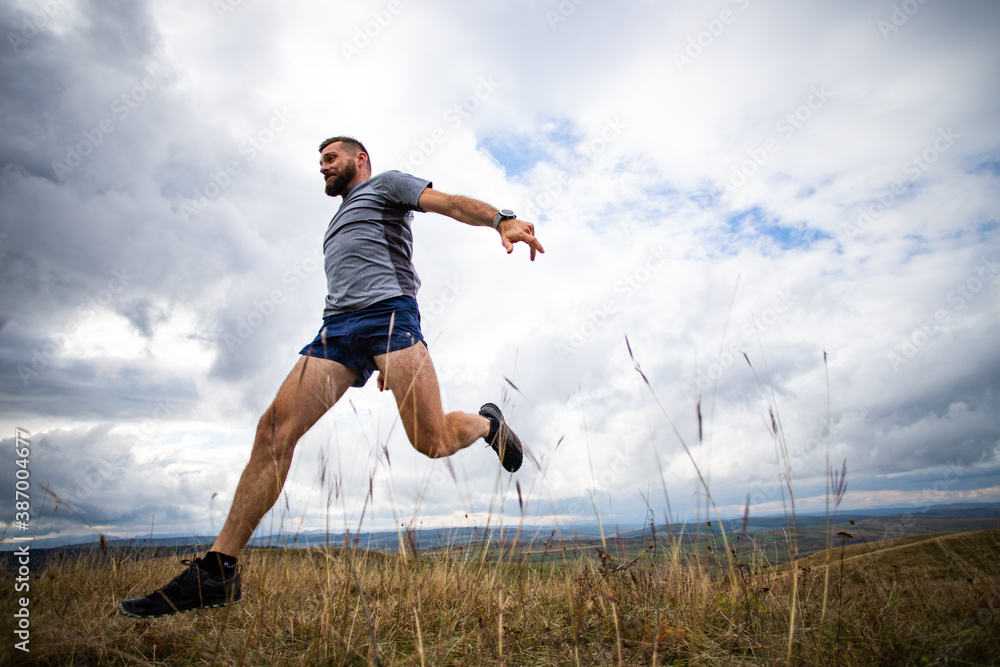 handsome trail runner running in nature handsome trail runner running in nature