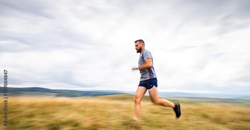handsome trail runner running in nature handsome trail runner running in nature