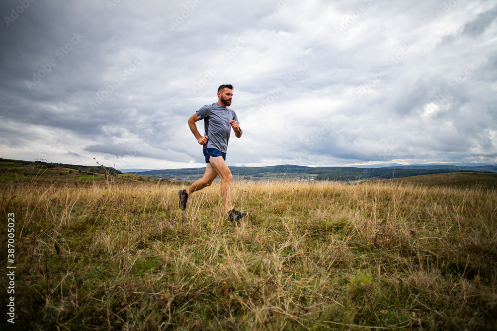 handsome trail runner running in nature handsome trail runner running in nature