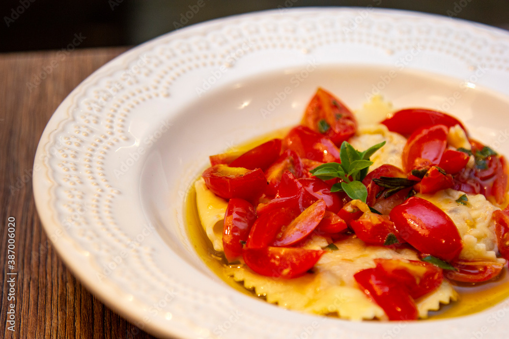 Ravioli with pieces of fresh tomato dipped in olive oil Ravioli with pieces of fresh tomato dipped in olive oil