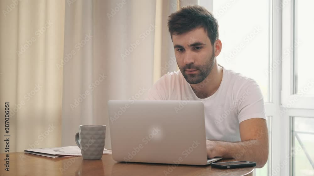 4k video of man sitting at the table working with laptop. 4k video of man sitting at the table working with laptop.