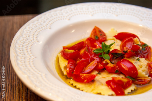 Ravioli with pieces of fresh tomato dipped in olive oil