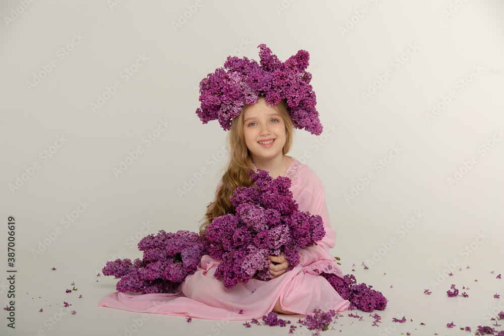 Fototapeta premium Little cute bright girl in the studio with lilac