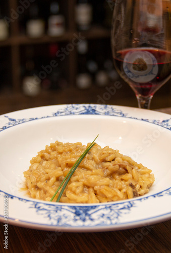 Risotto of funghi porcini with glass of wine photo