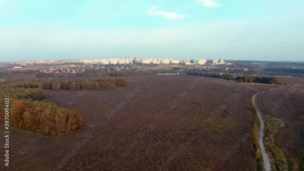 Video shooting from a drone. Field, woodland and city in the distance. Aerial video shoot the landscape Video shooting from a drone. Field, woodland and city in the distance. Aerial video shoot the landscape