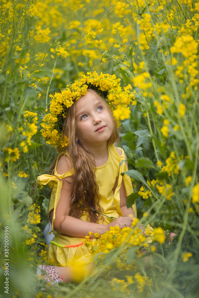 Little cute blonde girl on a rapeseed field Little cute blonde girl on a rapeseed field