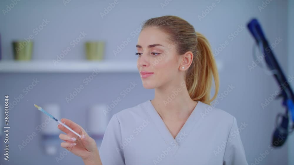Doctor Or Dentist Close Up Portrait In Hospital Or Clinic Hold Syringe With Blue Vaccine Covid19 Young Blonde Caucasian Confident Attractive Woman Slow Motion Medical Aesthetic Medicine Concept Doctor Or Dentist Close Up Portrait In Hospital Or Clinic Hold Syringe With Blue Vaccine Covid19 Young Blonde Caucasian Confident Attractive Woman Slow Motion Medical Aesthetic Medicine Concept