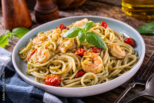 Photos Shrimp Pesto with basil, tomato and spaghetti.