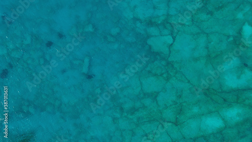 Aerial top down view photo of azure blue ocean. Beautiful bright green color of sea reef shallow water.