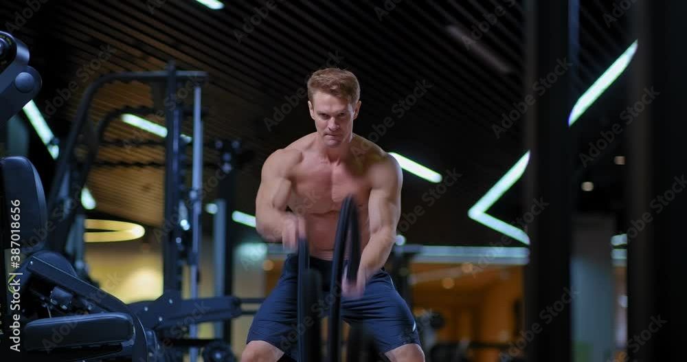 Professional male athlete twists the ropes with his hands, shakes the muscles of the hands. Training, ropes twisting by hand, exercises with ropes. 4k, ProRes Professional male athlete twists the ropes with his hands, shakes the muscles of the hands. Training, ropes twisting by hand, exercises with ropes. 4k, ProRes