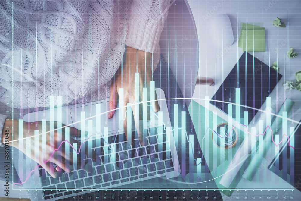 Multi exposure of woman hands working on computer and forex chart hologram drawing. Top View. Financial analysis concept. Multi exposure of woman hands working on computer and forex chart hologram drawing. Top View. Financial analysis concept.