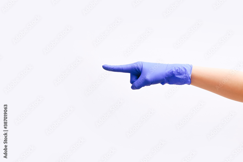 Doctor's hands in medical gloves showing a direction on white background