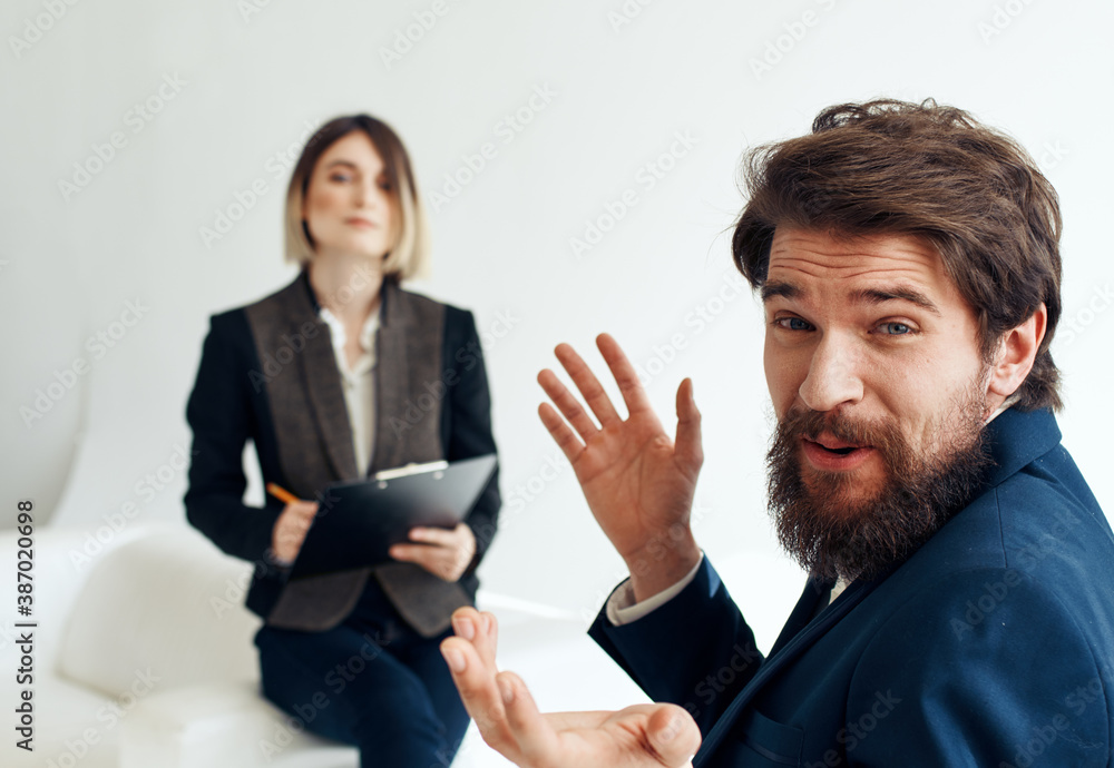and emotional man at job interview and business woman in suit in the background and emotional man at job interview and business woman in suit in the background