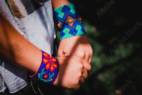 woman hands with handmade colorful bracelet