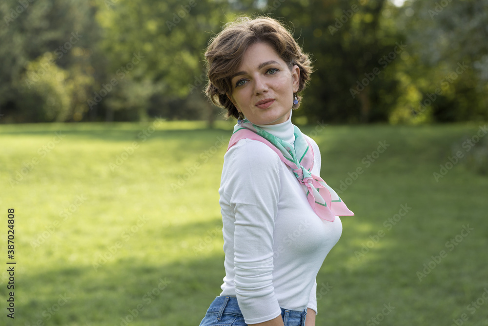 Young woman in the park. Cute girl portrait in french style. Young woman in the park. Cute girl portrait in french style.