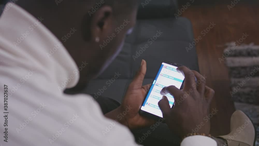 African black man using smartphone. Overshoulder shot. High quality 4k footage African black man using smartphone. Overshoulder shot. High quality 4k footage