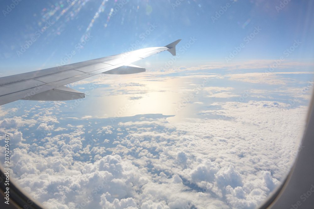 Fototapeta premium fluffy clouds in the sky shot from plane