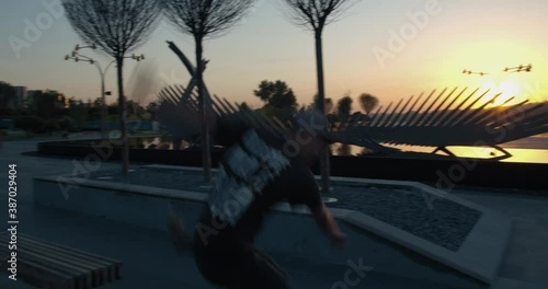 Young man is jumping from a park bench on a skateboard, 4k photo