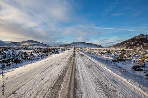 empty dirt road in snow covered lava field