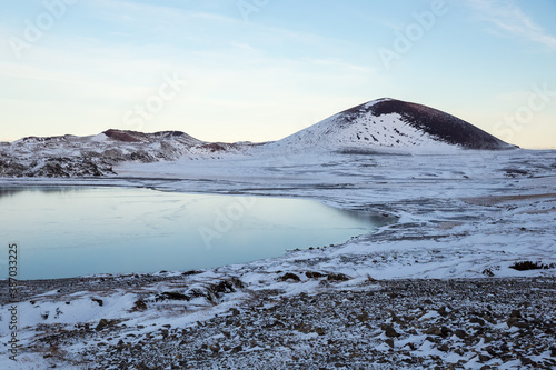 snow covered mountains and blue lake in winter