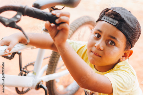 Brazilian child playing with his new bicycle.