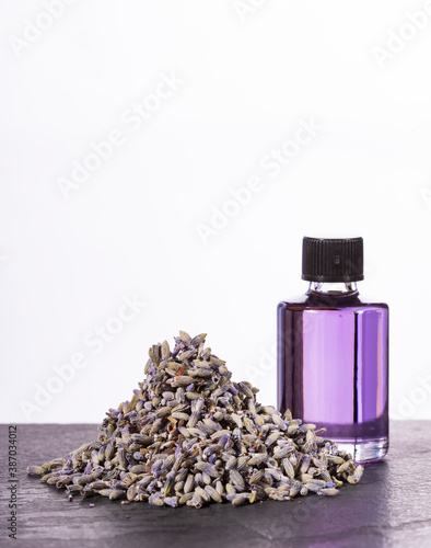 Lavandula - Lavender essential oil glass bottle with dried lavender flowers