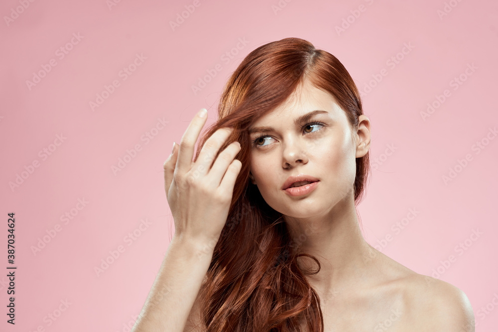 woman holding hair with hand problems hairstyle care emotions bare shoulders pink background woman holding hair with hand problems hairstyle care emotions bare shoulders pink background