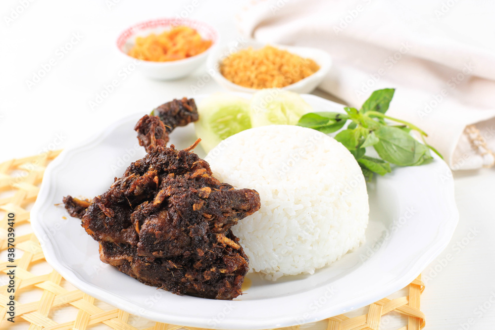 Bebek Madura, Traditional Fried Duck with Maduranese Typically Sauce. Usually Served with Raw Vegetable and Spicy Sambal. Popular as Penyetan