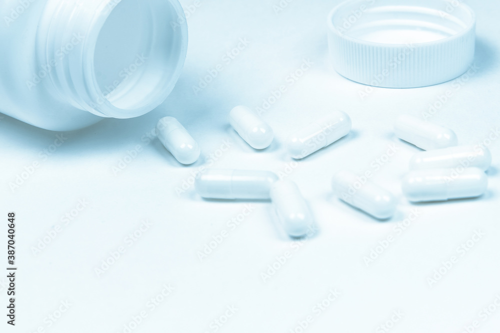 bottle and pills on a white background. bottle and pills on a white background.
