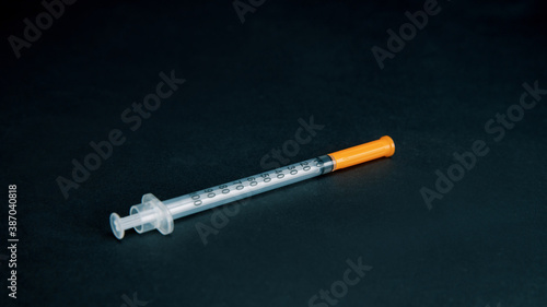 insulin sinsulin syringe on a black background . photo with a copy-space.yringe on a black background .