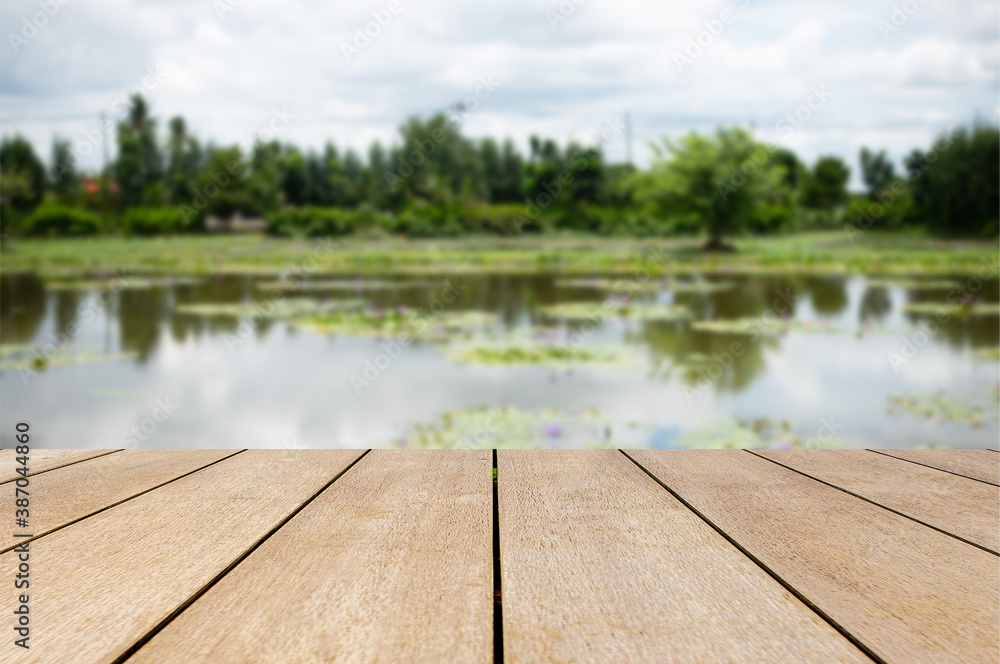 Empty old wooden table in front of abstract blurred lake mountain and forest background of nature. Can be used for display or montage for your products. Empty old wooden table in front of abstract blurred lake mountain and forest background of nature. Can be used for display or montage for your products.
