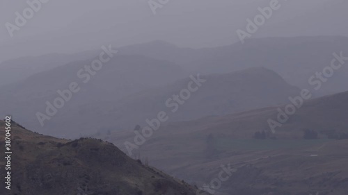 New Zealand autumn season landscape with mountains during rain. photo