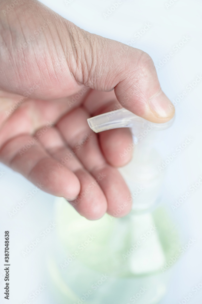 Hand was holding bottle of hand sanitizer. Hand was holding bottle of hand sanitizer.