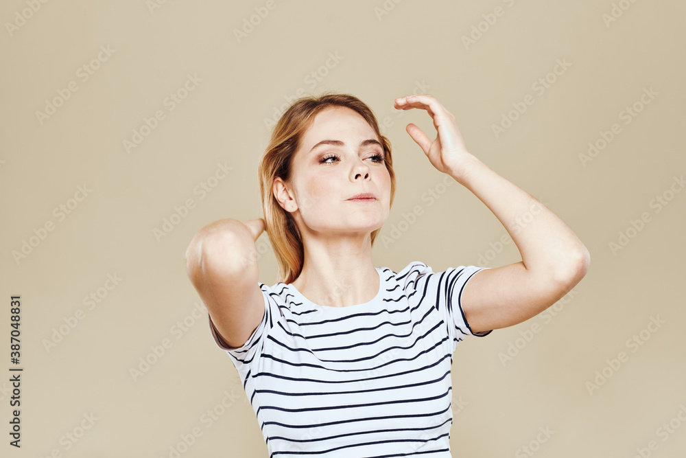 Cute blonde striped t-shirt smile lifestyle beige studio background Cute blonde striped t-shirt smile lifestyle beige studio background