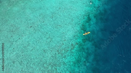 Birds Eye Aerial View of Kayak With Two People in Turquoise Water, Maldives Island Arhipelago, Indian Ocean. Luxury Tropical Destination Activity, High Angle Static Drone Shot photo