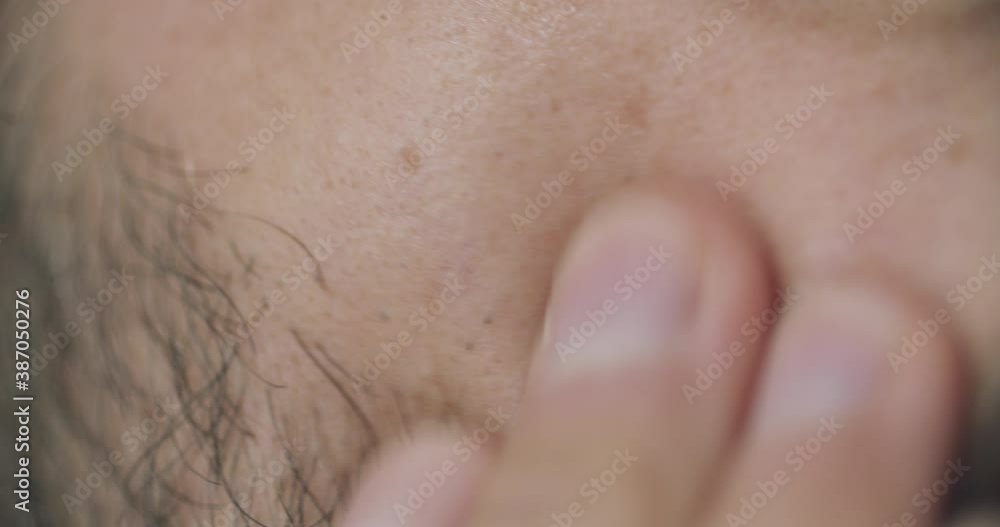 Close up shot of a man checking his right cheek after shaving. Caucasian man with beard after shave. Close up shot of a man checking his right cheek after shaving. Caucasian man with beard after shave.