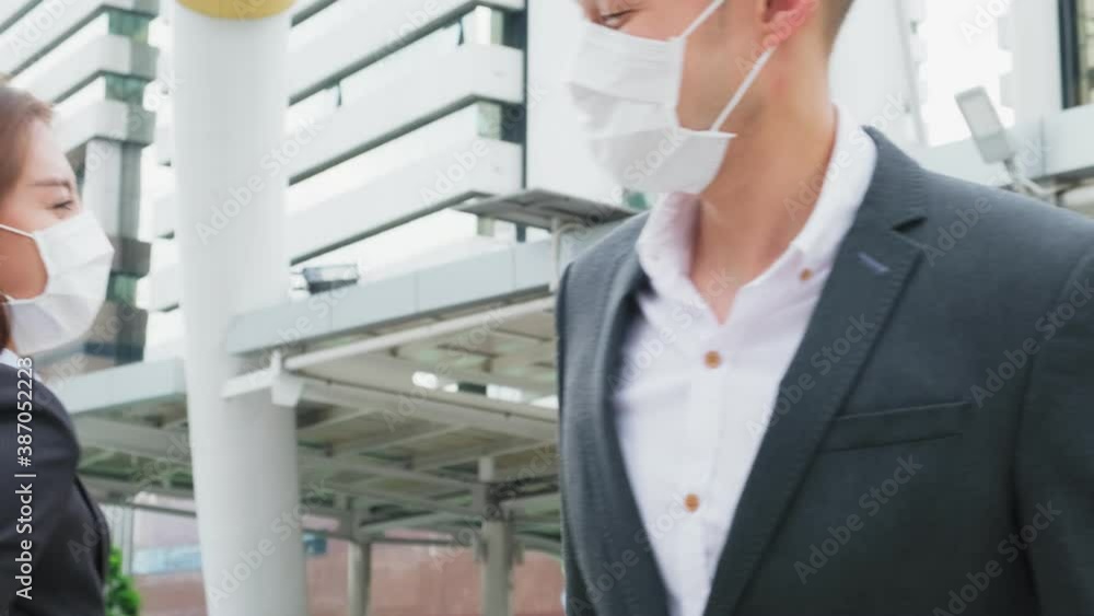 Asian young business people wearing face mask, Greeting by elbow touch Asian young business people wearing face mask, Greeting by elbow touch