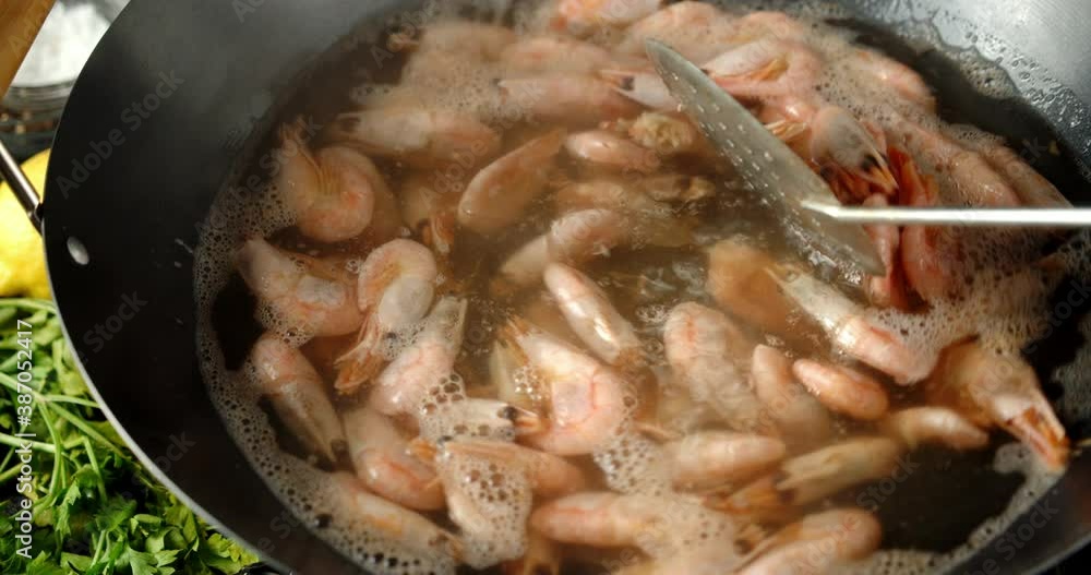 Cooking delicious boiled shrimp. On a dark background. Cooking delicious boiled shrimp. On a dark background.