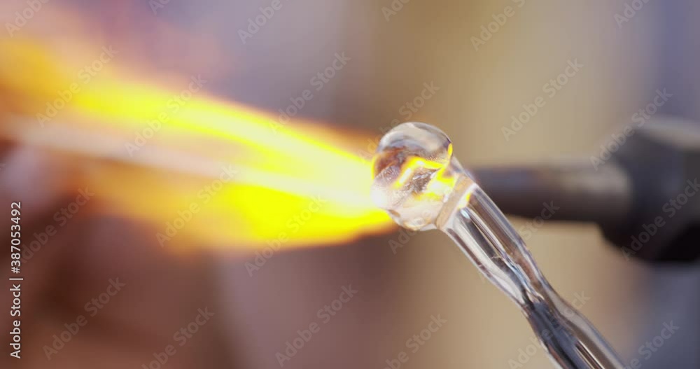Glass work with flame. Slow motion close up of glass statuary shaping with flame on a handmade in workshop. Concept of handmade, high quality, glass blower work Glass work with flame. Slow motion close up of glass statuary shaping with flame on a handmade in workshop. Concept of handmade, high quality, glass blower work
