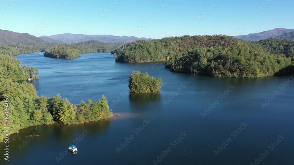 Aerial view of Lake Santeetlah, North Carolina and surrounding national forests in autumn color 4K. Aerial view of Lake Santeetlah, North Carolina and surrounding national forests in autumn color 4K.