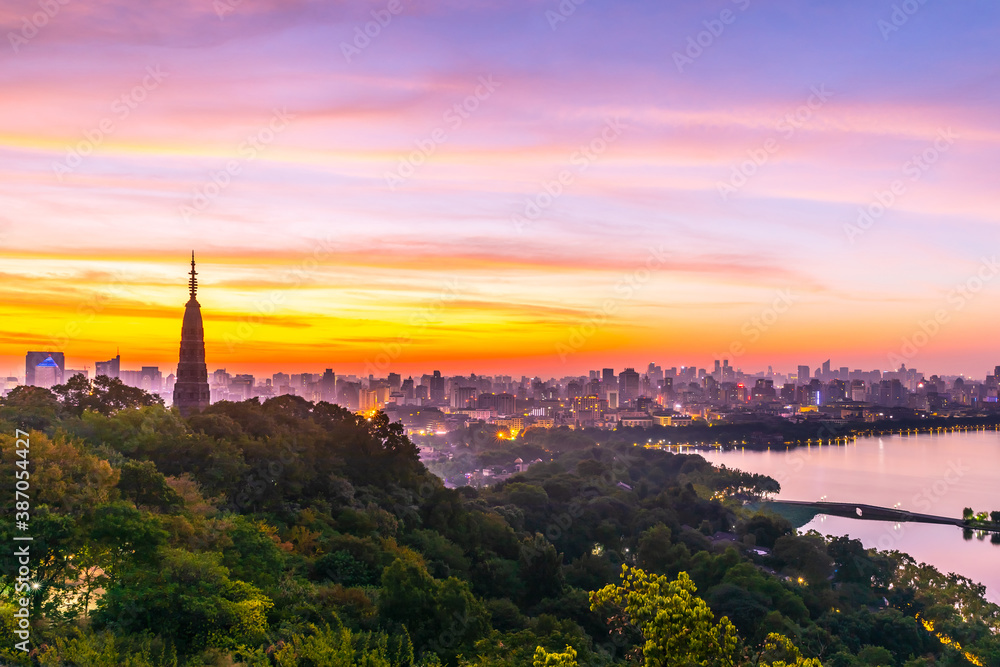 Ancient Baochu Pagoda.Chinese traditional architecture and modern city skyline in Hangzhou at sunrise,China.