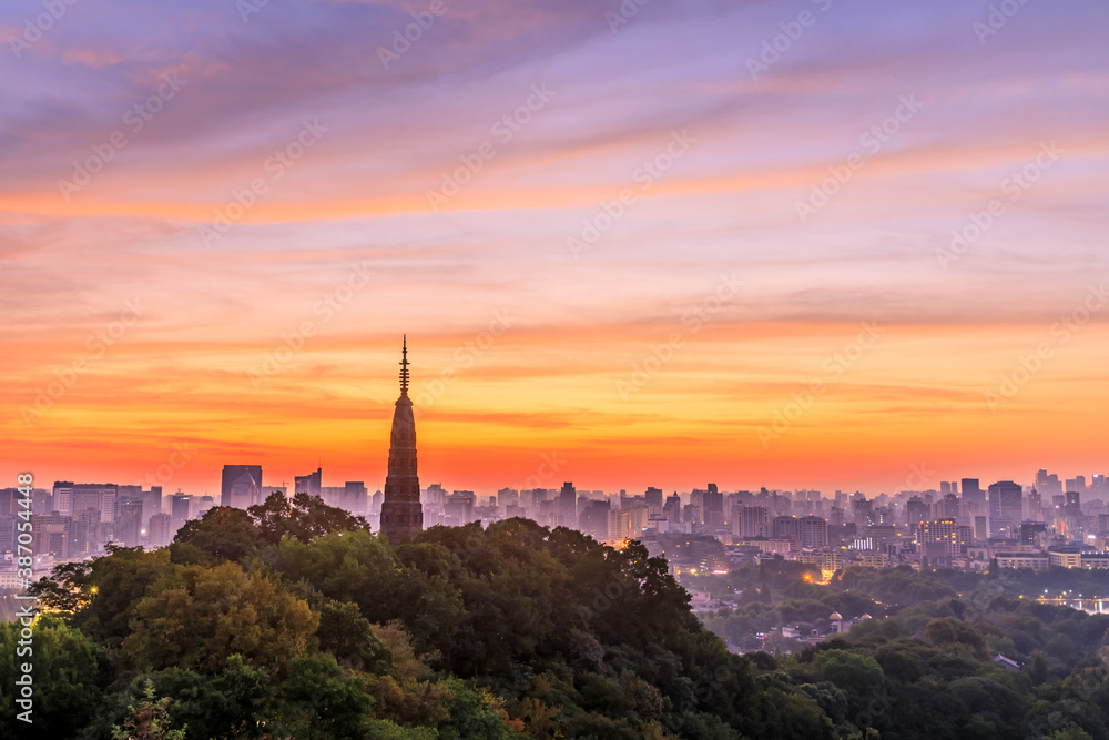 Naklejka premium Ancient Baochu Pagoda.Chinese traditional architecture and modern city skyline in Hangzhou at sunrise,China.
