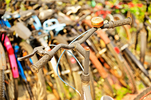 Close-up shot of a bicycle handlebar in a bicycles parked slot