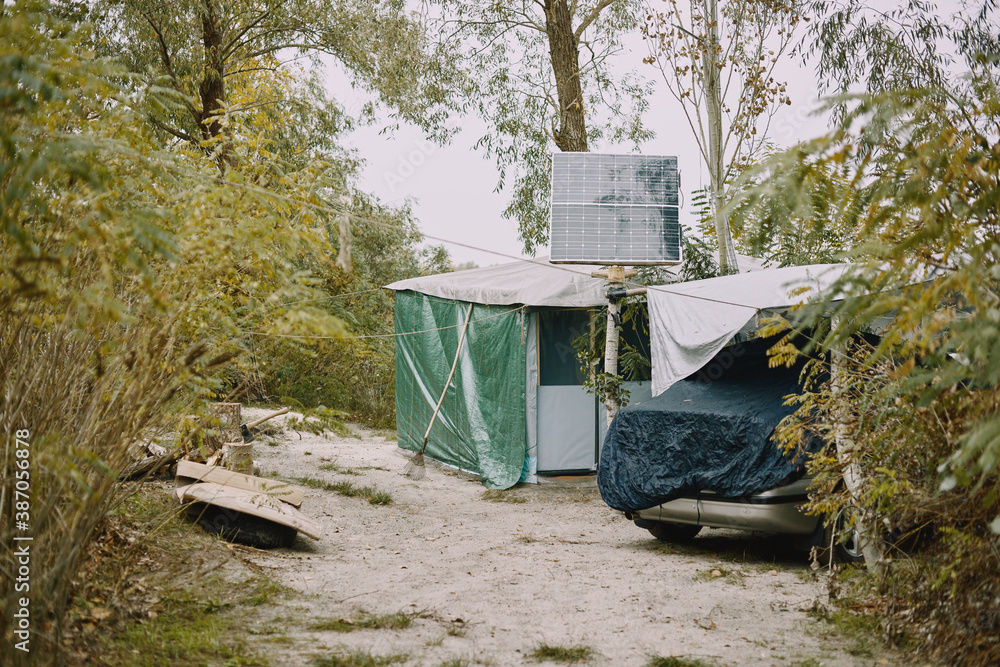Solar battery on a makeshift house near the river in the forest. Solar battery on a makeshift house near the river in the forest.
