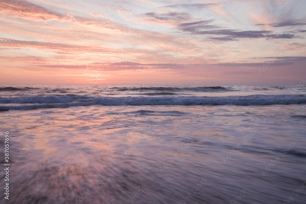 Fototapeta premium Sunrise over slow motion blurred water 