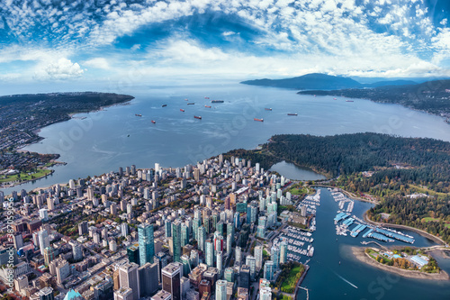 Aerial View of Downtown Vancouver, Coal Harbour and Stanley Park. Taken during a bright sunny morning in British Columbia, Canada. Modern Cityscape from above. photo