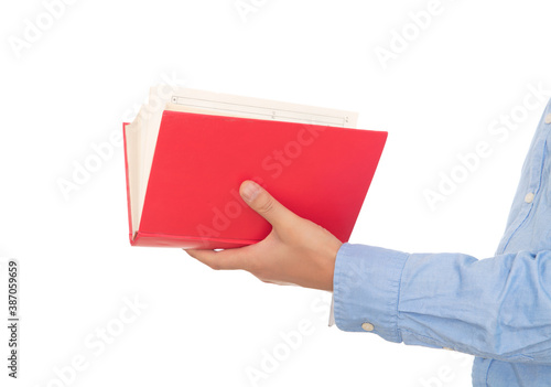Hand holding a red book in front of the background