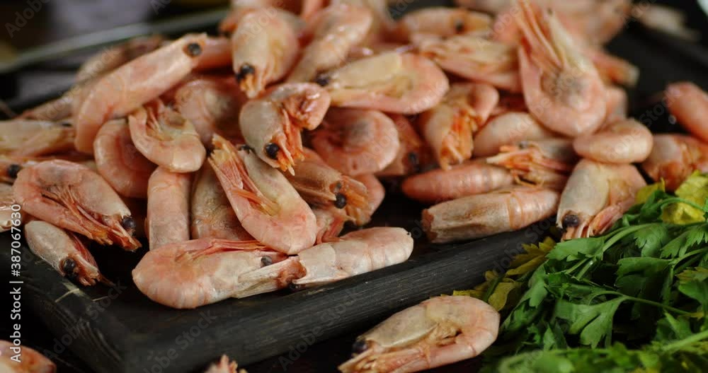 Delicious boiled shrimp on a cutting board rotate. Delicious boiled shrimp on a cutting board rotate.