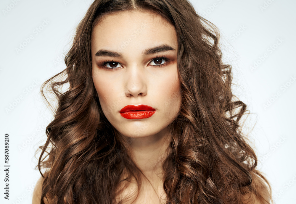 Portrait of a beautiful woman with red lips and curly hair at the barbershop Portrait of a beautiful woman with red lips and curly hair at the barbershop