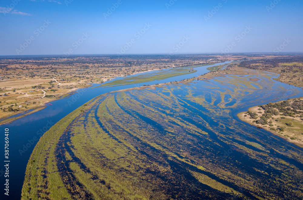 Okavango delta landscape on Namibia and Angola border. Aerial landscape of famous river with shore and green vegetation after rainy season. Africa aerial landscape.